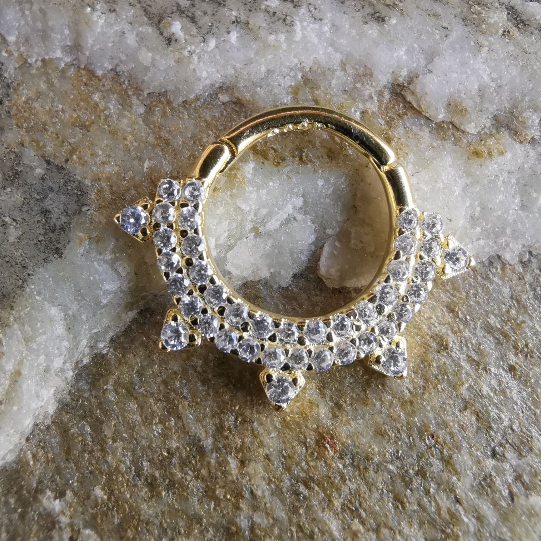 Refined and radiant septum ring piercing combining the shine of gold with the strength of sterling silver.
