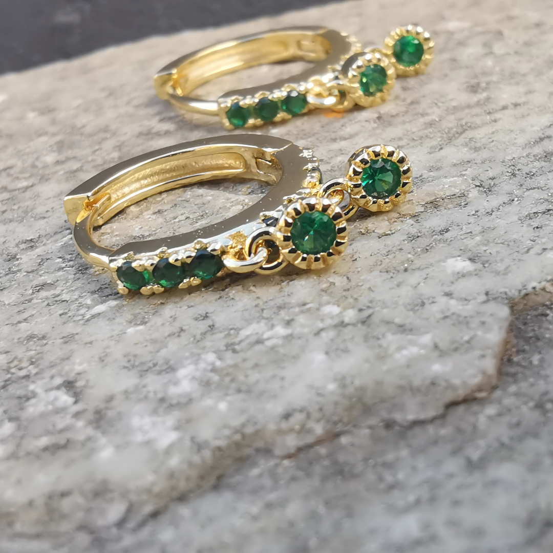 Stylish green emerald zirconia hoop ear piercings crafted from 925 sterling silver with gold plating.