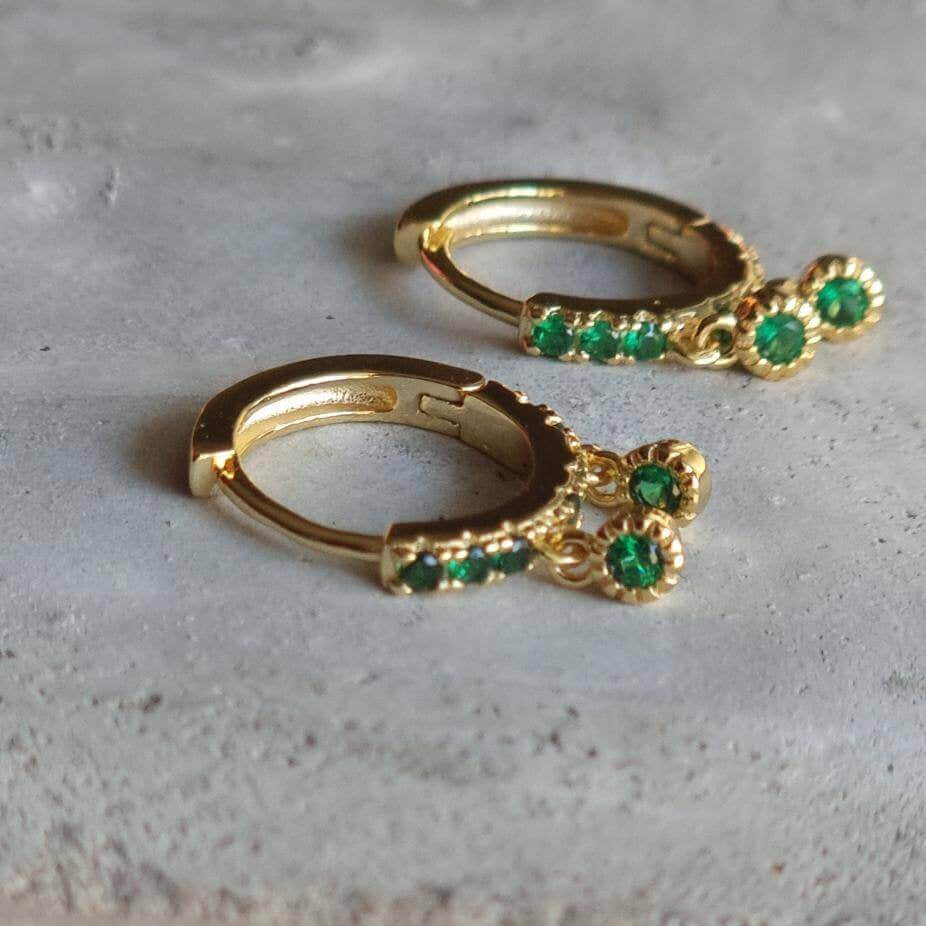 Chic gold hoop earrings featuring vivid green emerald 5A zirconia stones on sterling silver.