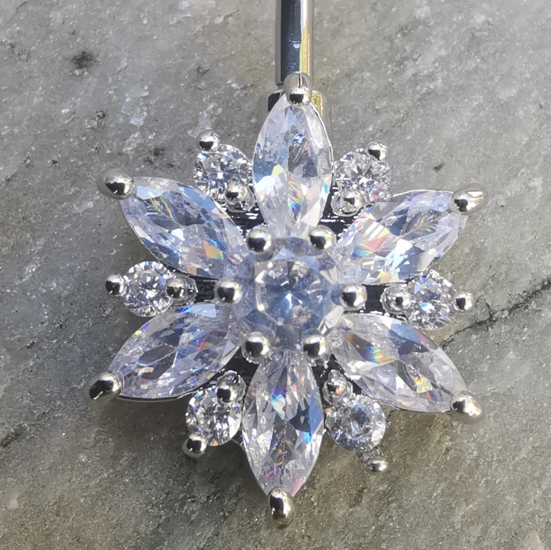 Floral-style end piece on a 14 gauge silver-tone 316L surgical steel navel barbell.
