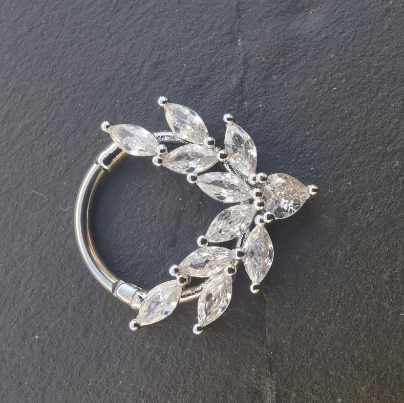 The silver clicker ring styled in a daith piercing, demonstrating its versatility and comfort.