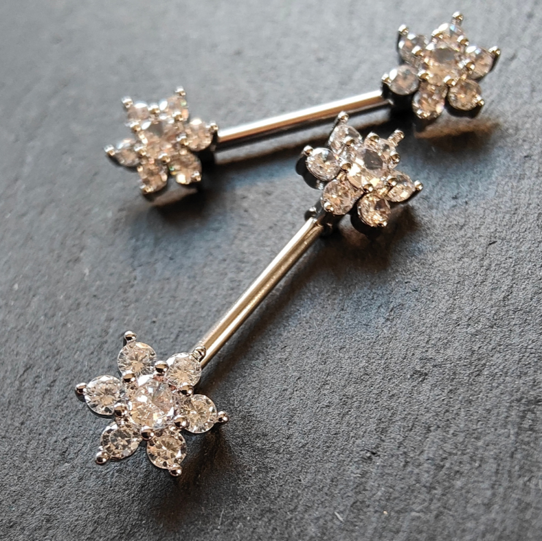 Elegant flower nipple bar jewelry in silver with cubic zirconia, made with 14G surgical steel 316L.