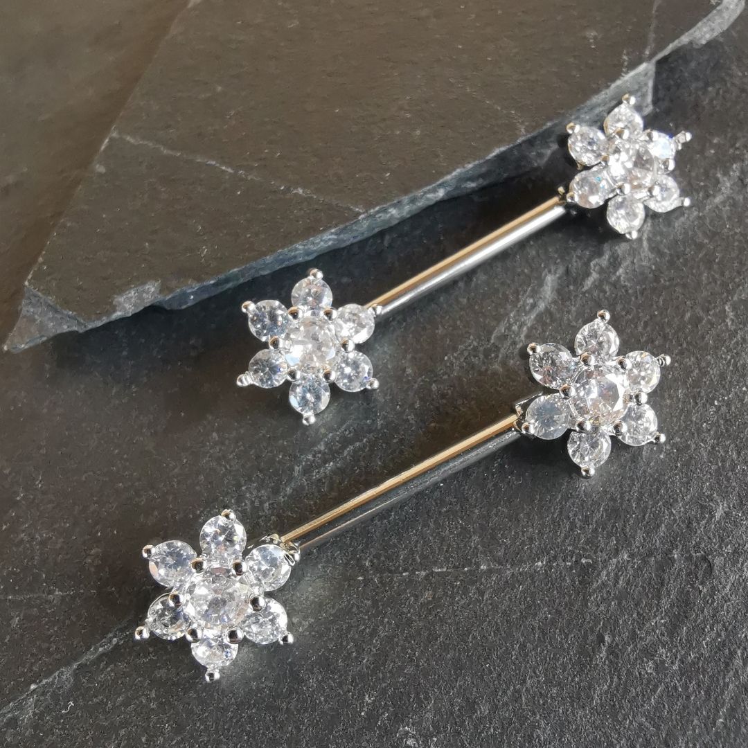Silver flower nipple bar piercing featuring dazzling cubic zirconia, crafted from 14G surgical steel 316L.