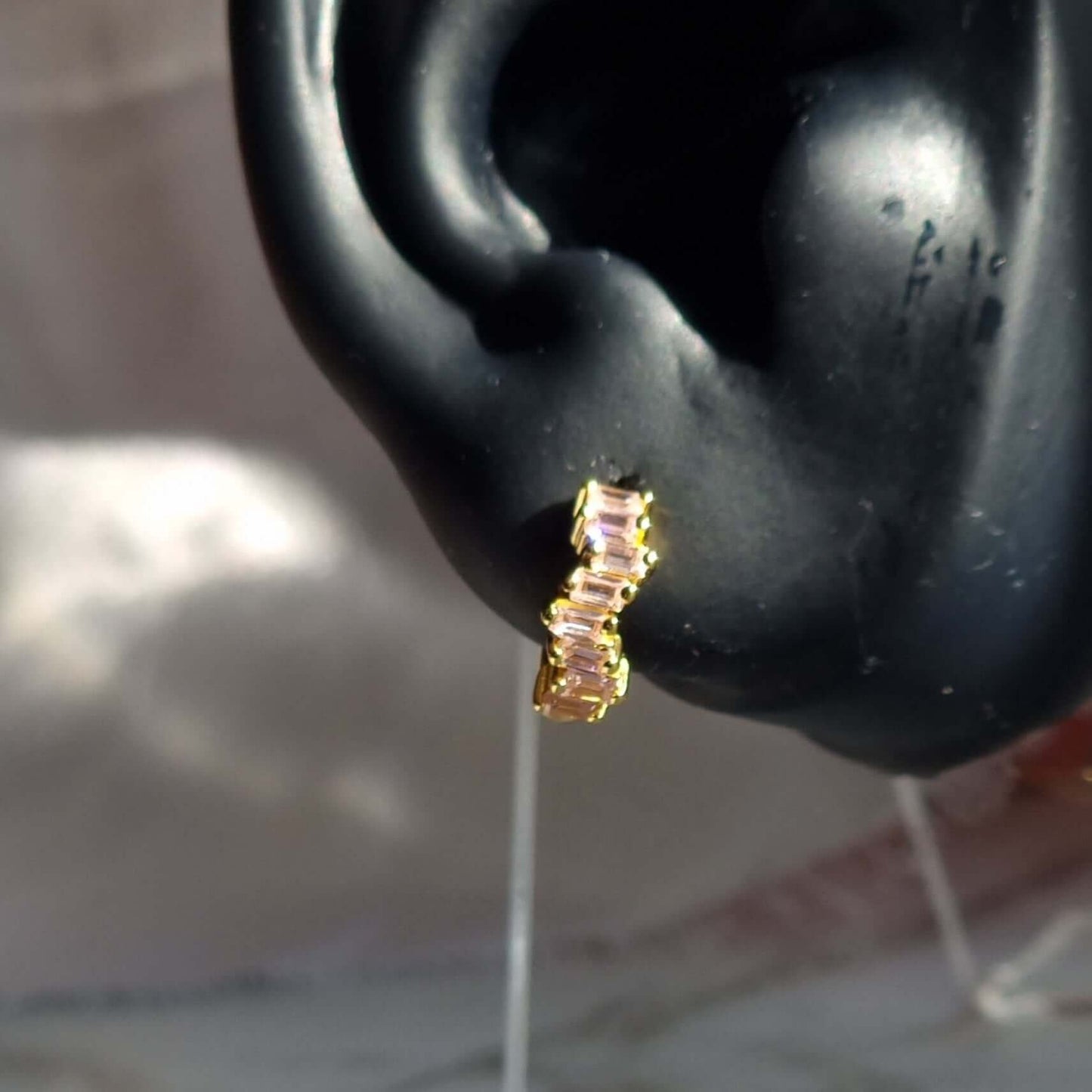 Detailed image of rectangular pink cubic zirconia huggie earrings in 18K gold-plated sterling silver, perfect for everyday wear or stacking.