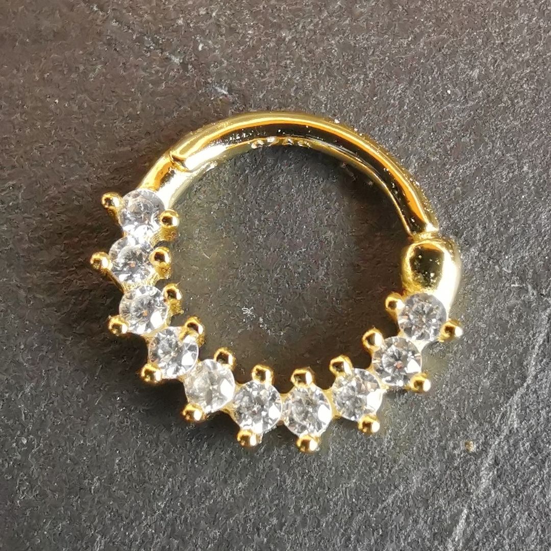 Chic and refined gold septum piercing jewelry with a dainty 18G ring design in sterling silver.