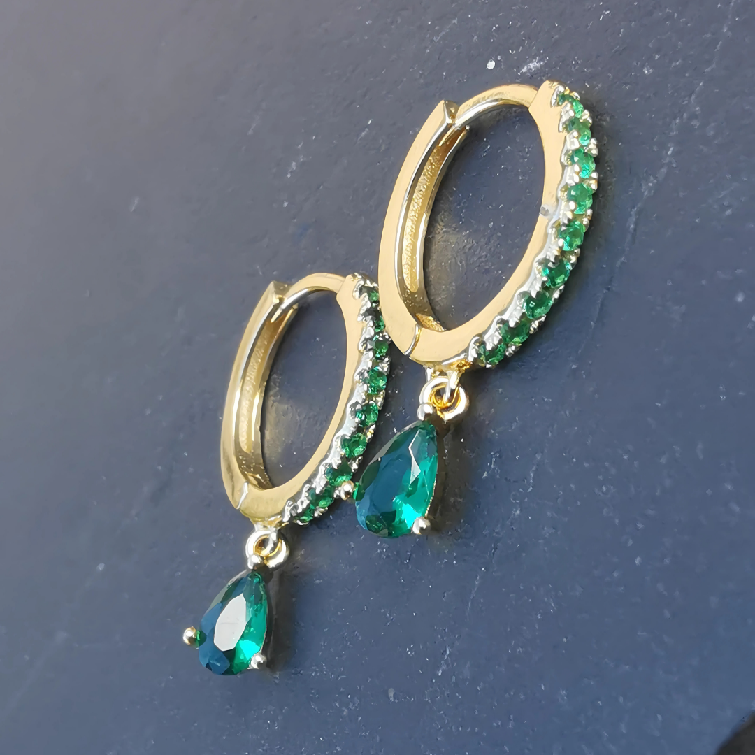 Chic ear piercing set featuring vibrant green zirconia drops on a luxurious 18K gold plated sterling silver base.