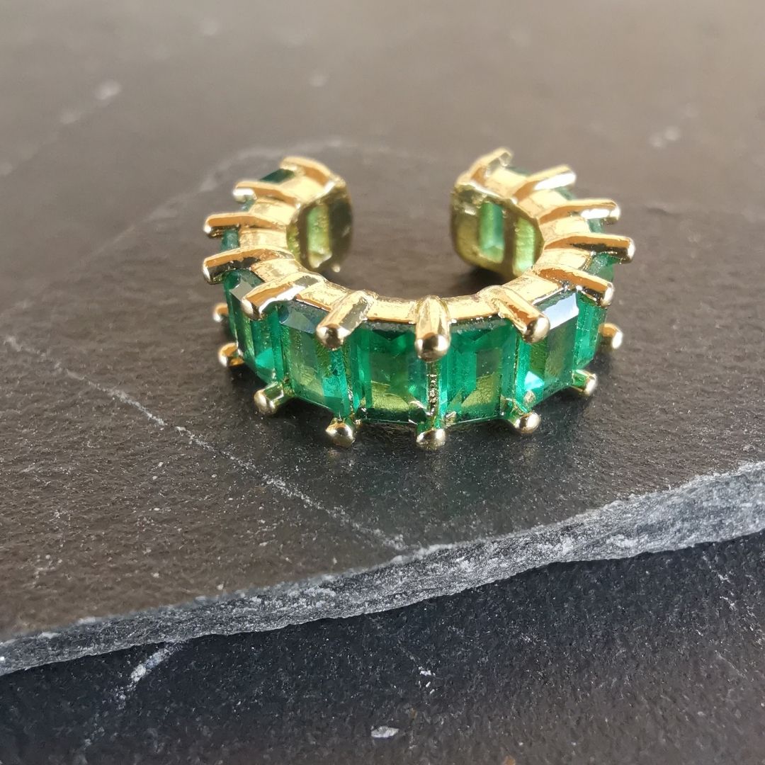 Green gem conch ear cuff in 18K gold-plated copper, featuring a brilliant green cubic zirconia and no-piercing adjustable fit for the conch area.