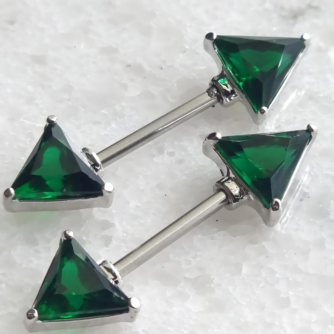 14G surgical steel nipple bar featuring a triangle design with green gems and cubic zirconia accents.