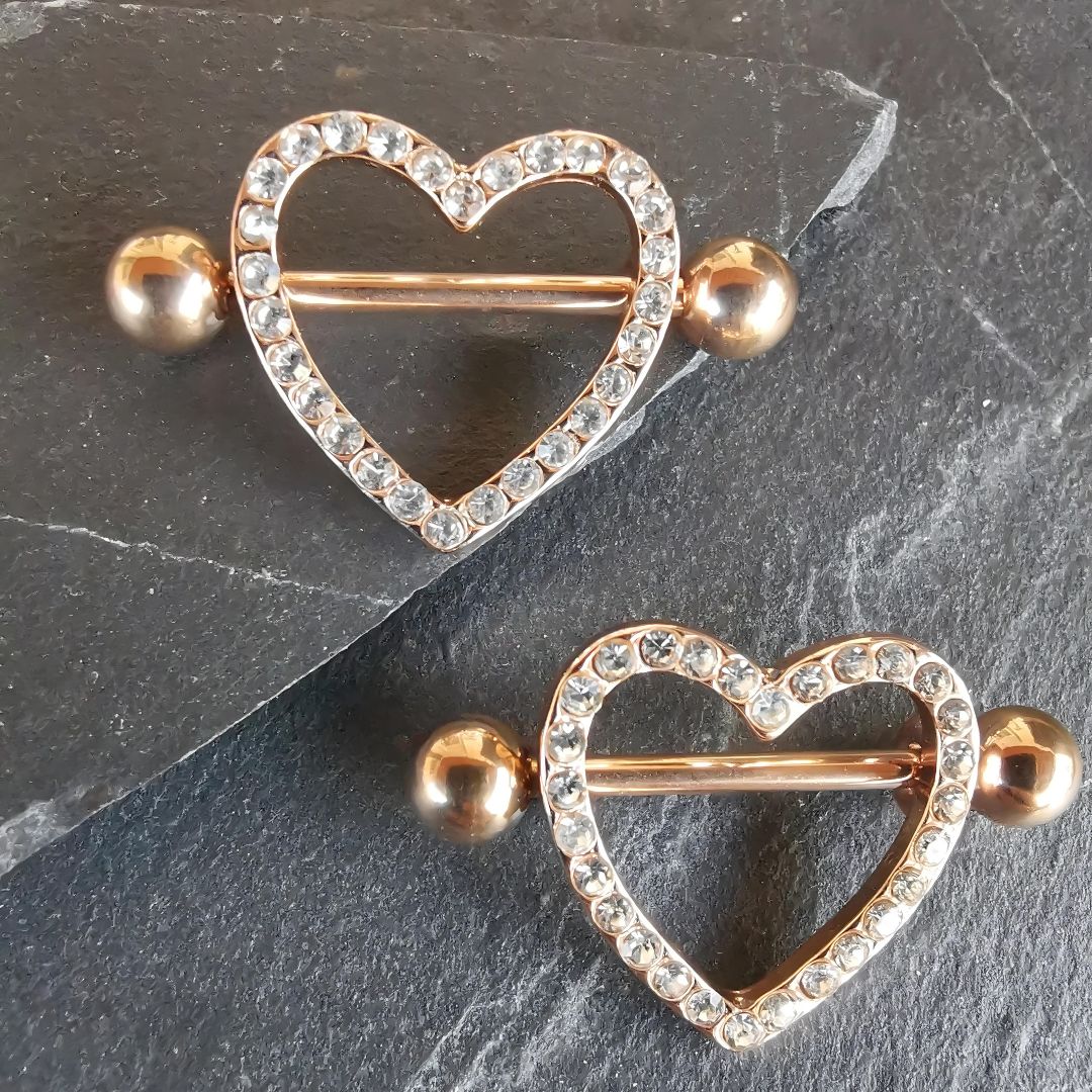 Heart nipple piercing shield bars in 14G rose gold surgical steel 316L, elegant body jewelry.