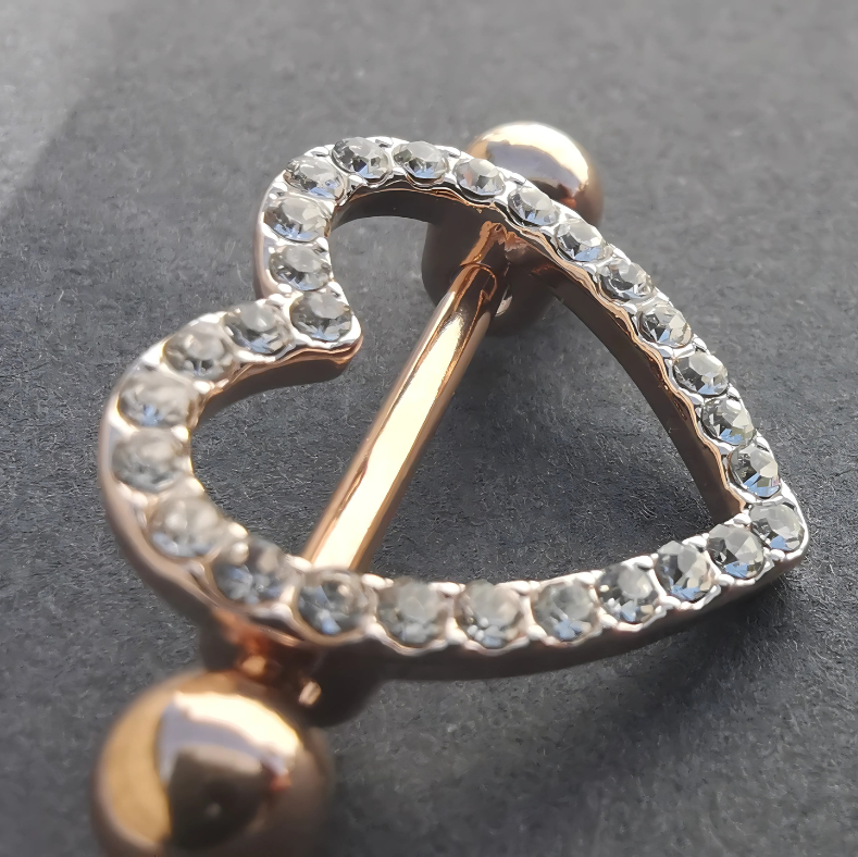14G rose gold surgical steel nipple shield bar with a delicate heart design for stylish piercings.