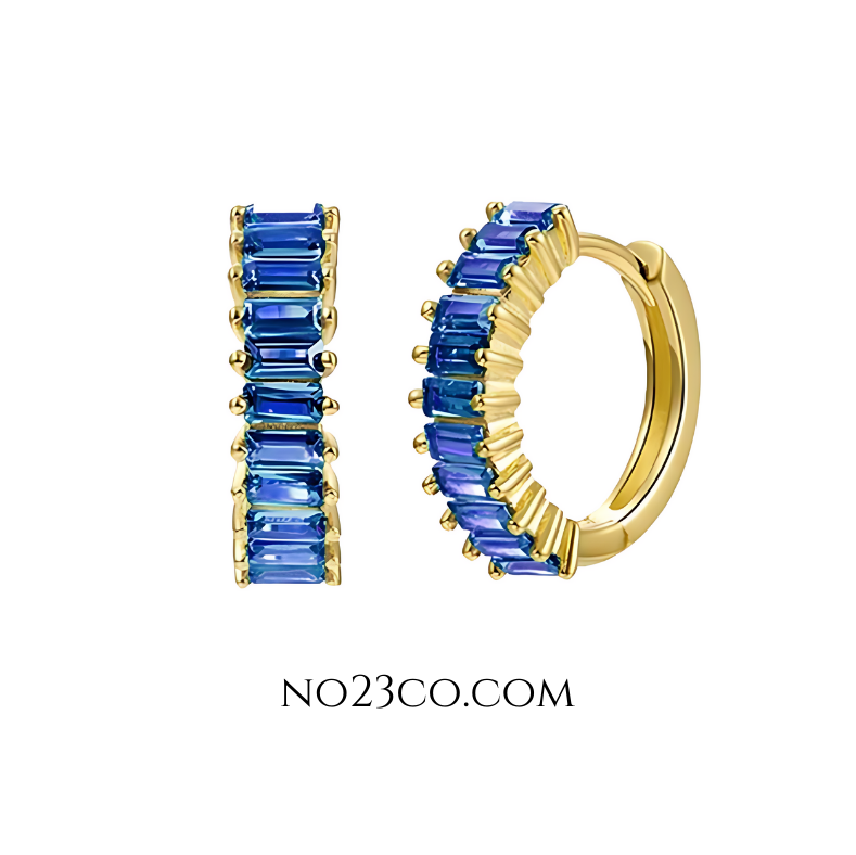 Blue zirconia huggie earrings crafted in 18K gold-plated 925 sterling silver, featuring rectangular-cut clear stones and a minimalist hoop design.
