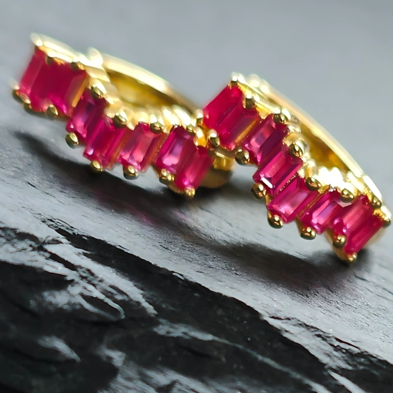Magenta cubic zirconia huggie earrings in 18K gold-plated 925 sterling silver, featuring rectangular-cut vibrant stones and a polished hoop design.