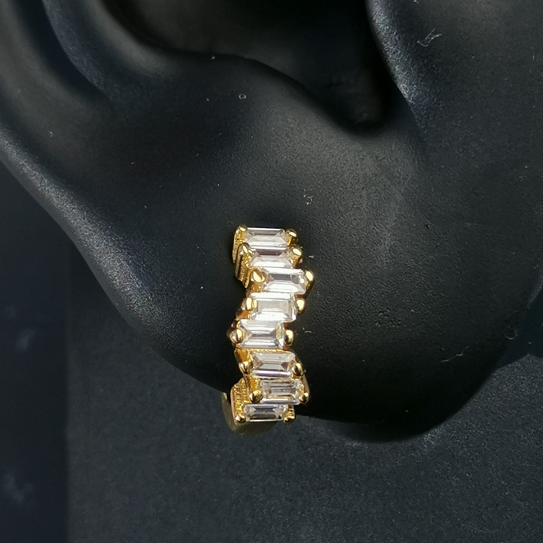 Elegant white cubic zirconia huggie earrings in 18K gold-plated 925 sterling silver, offering timeless sparkle and refined everyday style.