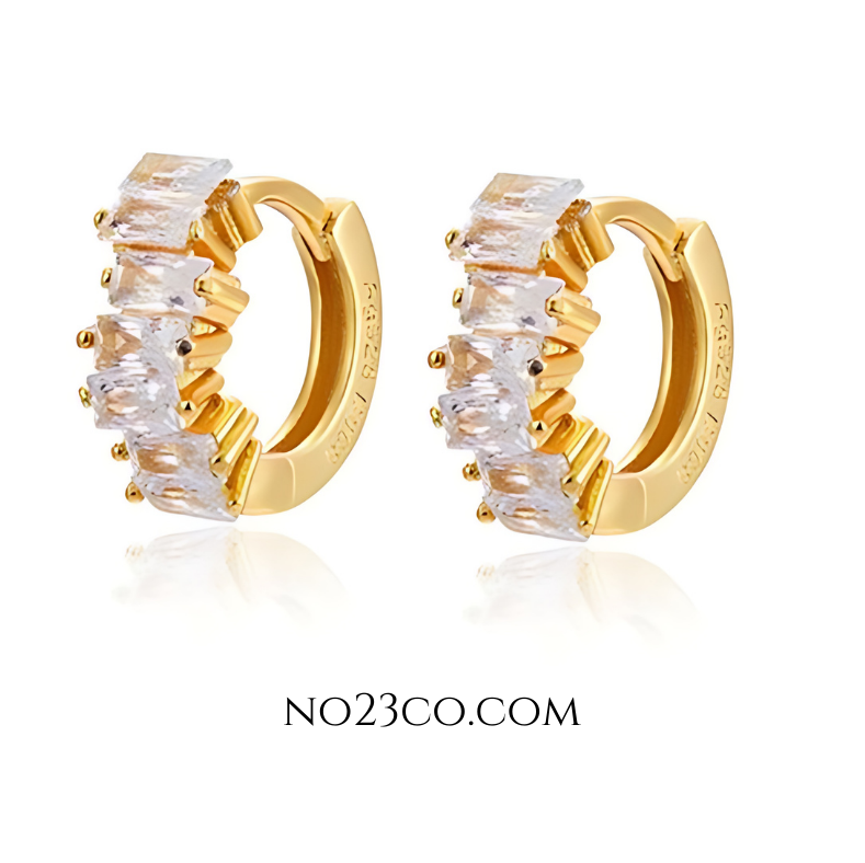 White cubic zirconia huggie earrings in 18K gold-plated 925 sterling silver, featuring rectangular-cut stones and a sleek hoop silhouette.