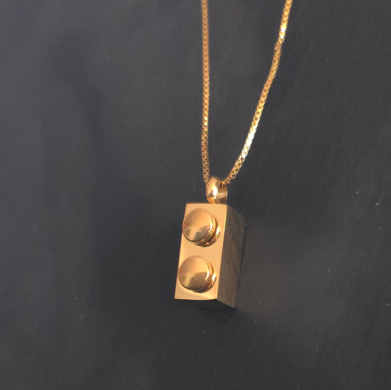 Lego Rectangle Brick Necklace in 18K Gold – A sleek and modern necklace featuring a Lego-inspired rectangle brick pendant, crafted from durable stainless steel with 18K gold PVD plating. Waterproof and sweatproof for everyday wear.