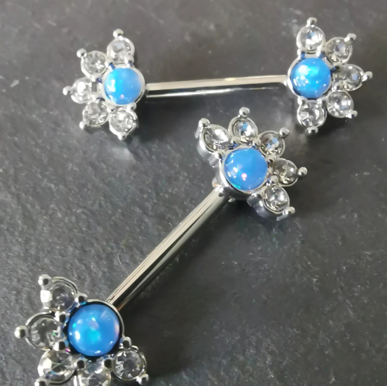 Elegant mandala flower nipple bar jewelry in silver with a blue centerpiece and cubic zirconia, 14G surgical steel 316L.
