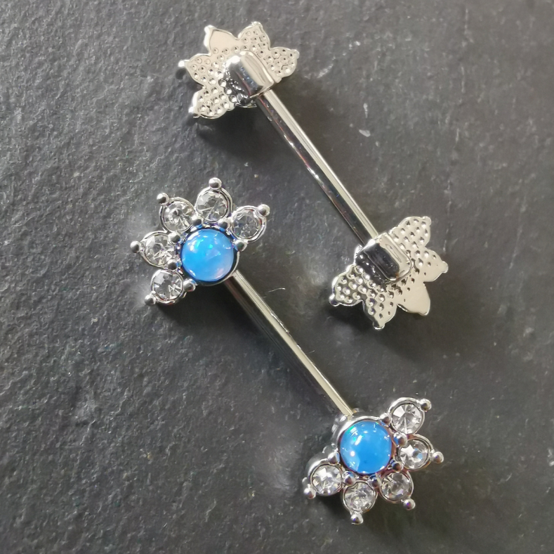 14G surgical steel nipple bar with a mandala flower design, blue stone, and cubic zirconia, in silver finish