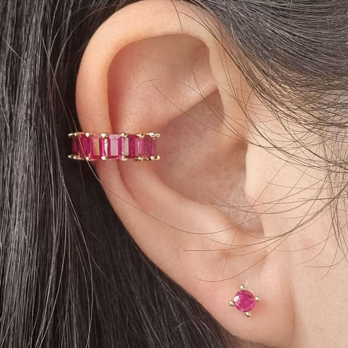 Minimalist gold conch cuff earring with vibrant magenta zirconia stone, designed for secure, comfortable wear on unpierced ears.