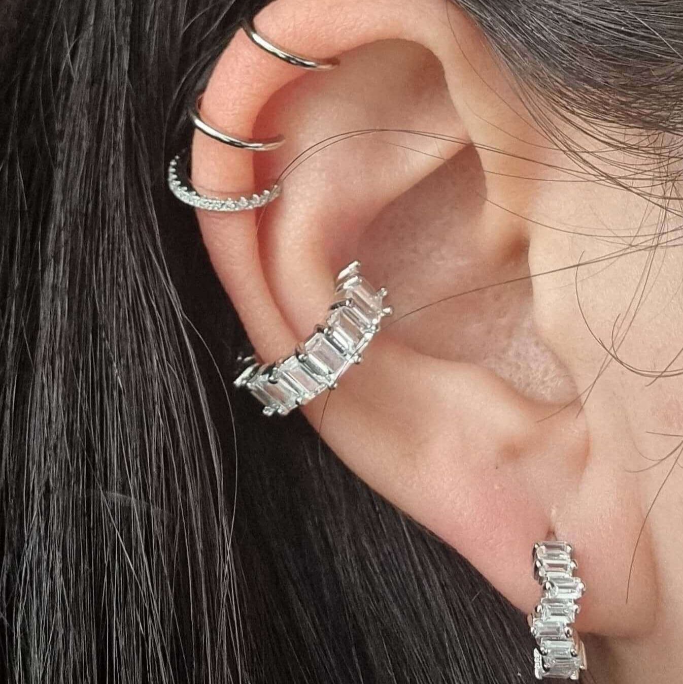 White gem conch ear cuff made from silver-plated copper, featuring a sparkling cubic zirconia and no piercing required for easy ear styling.