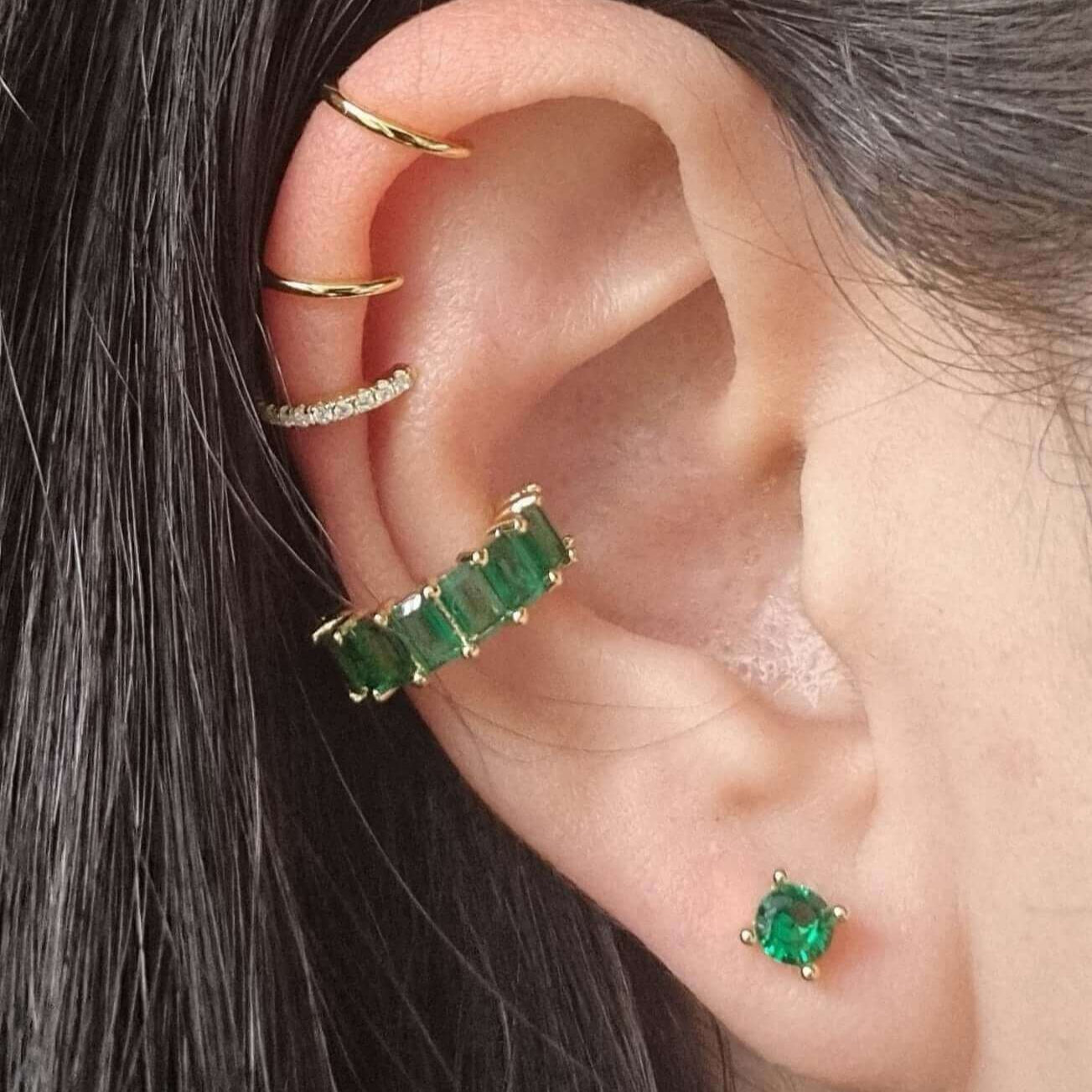 Elegant green gem ear cuff for the conch, made from polished gold-plated copper with a no-piercing design for a comfortable, snug fit.