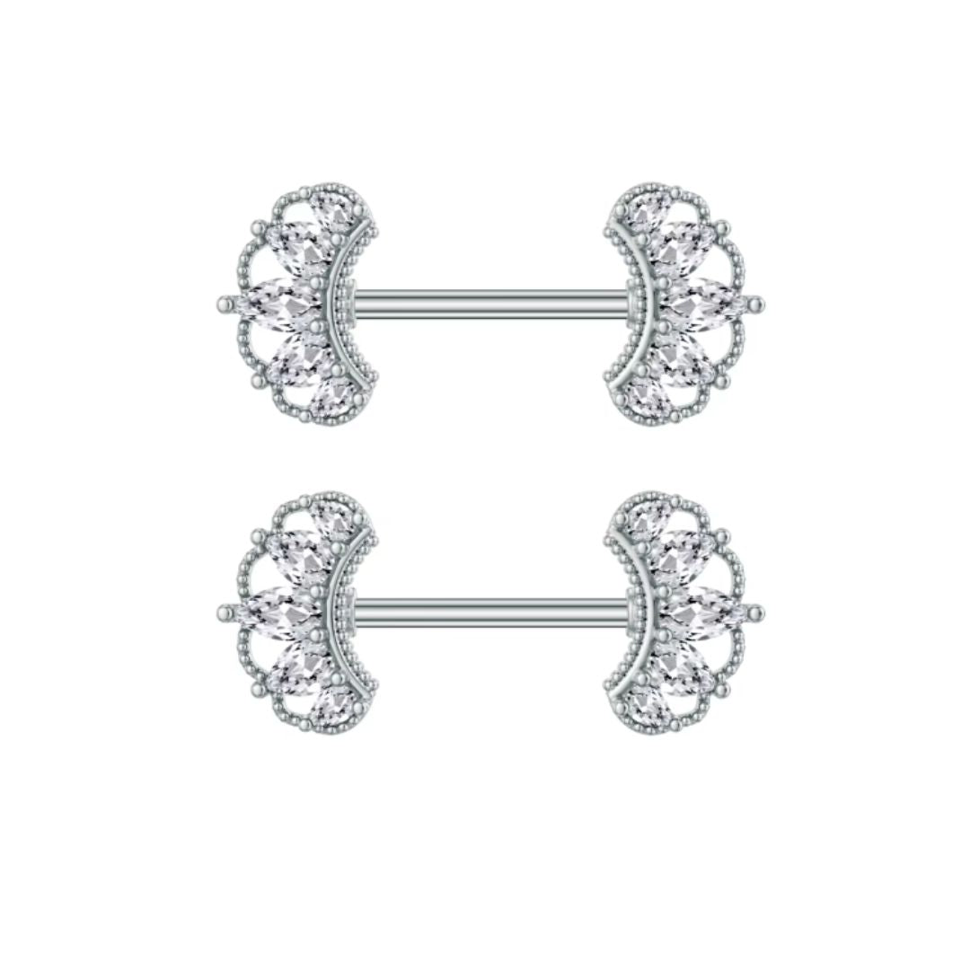 Pair of silver nipple rings with crown designs on a white background