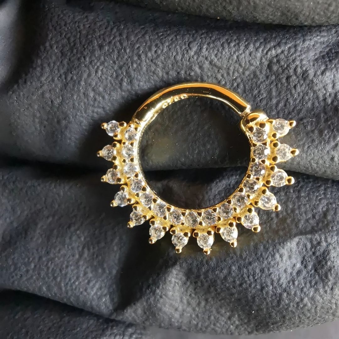 Chic and shiny 18-gauge gold daith ring adorned with brilliant CZ stones for a touch of glam.