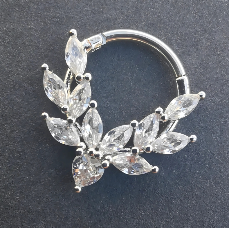A model wearing the silver clicker ring in a septum piercing, highlighting its elegant and stylish appearance.