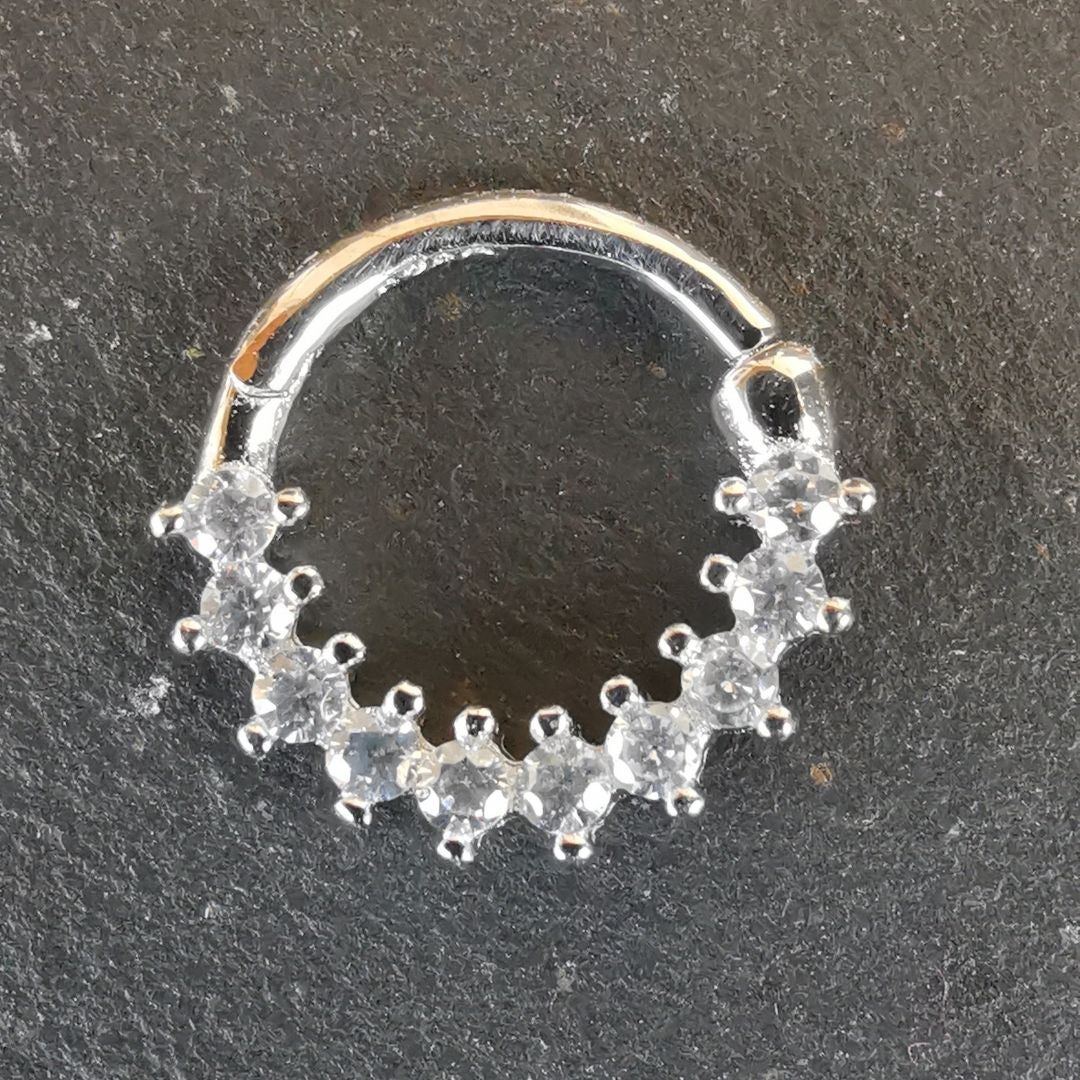 Tiny 18 gauge silver septum ring featuring brilliant CZ stones for a hint of shimmer.