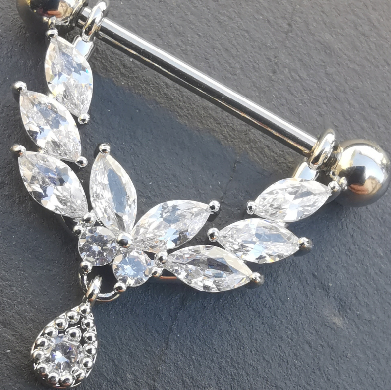 Silver shield‑dangle nipple piercing barbell showcasing clear CZ crystals and a high‑polish surgical steel finish.