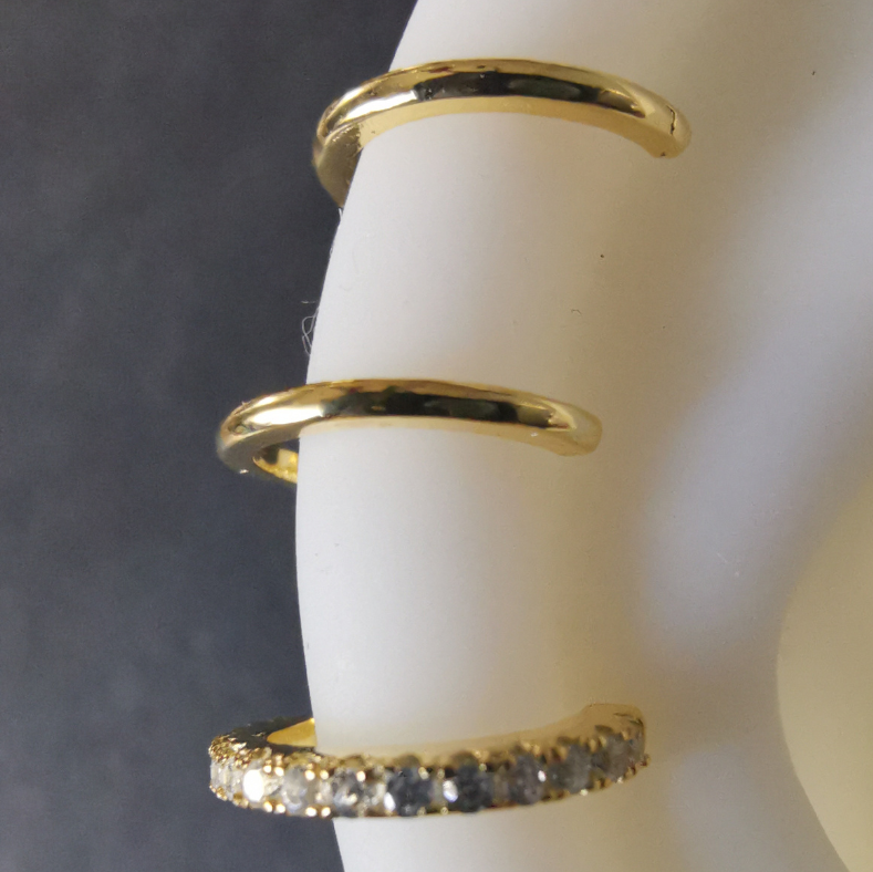 Detailed angle of a no-piercing triple hoop ear cuff, highlighting interconnected loops in luxurious 18K gold plated 925 sterling silver.