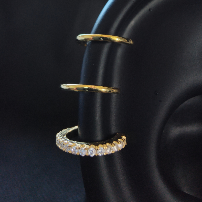 Triple hoop ear cuff crafted from 925 sterling silver with 18K gold plating, featuring three interconnected hoops for a bold, no-piercing design.