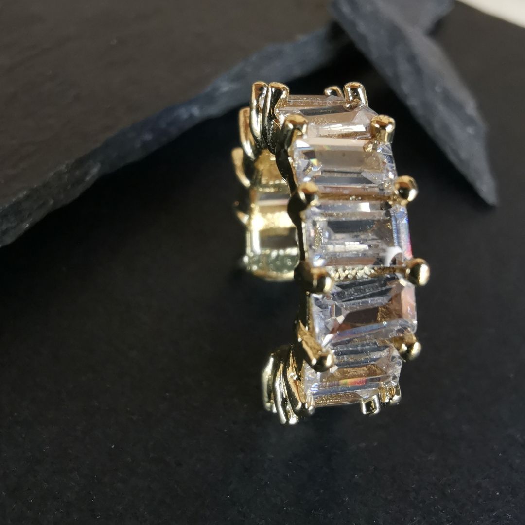 Non-pierced conch ear cuff earring in polished 18K gold-plated copper, featuring a small white cubic zirconia for a chic, modern look.