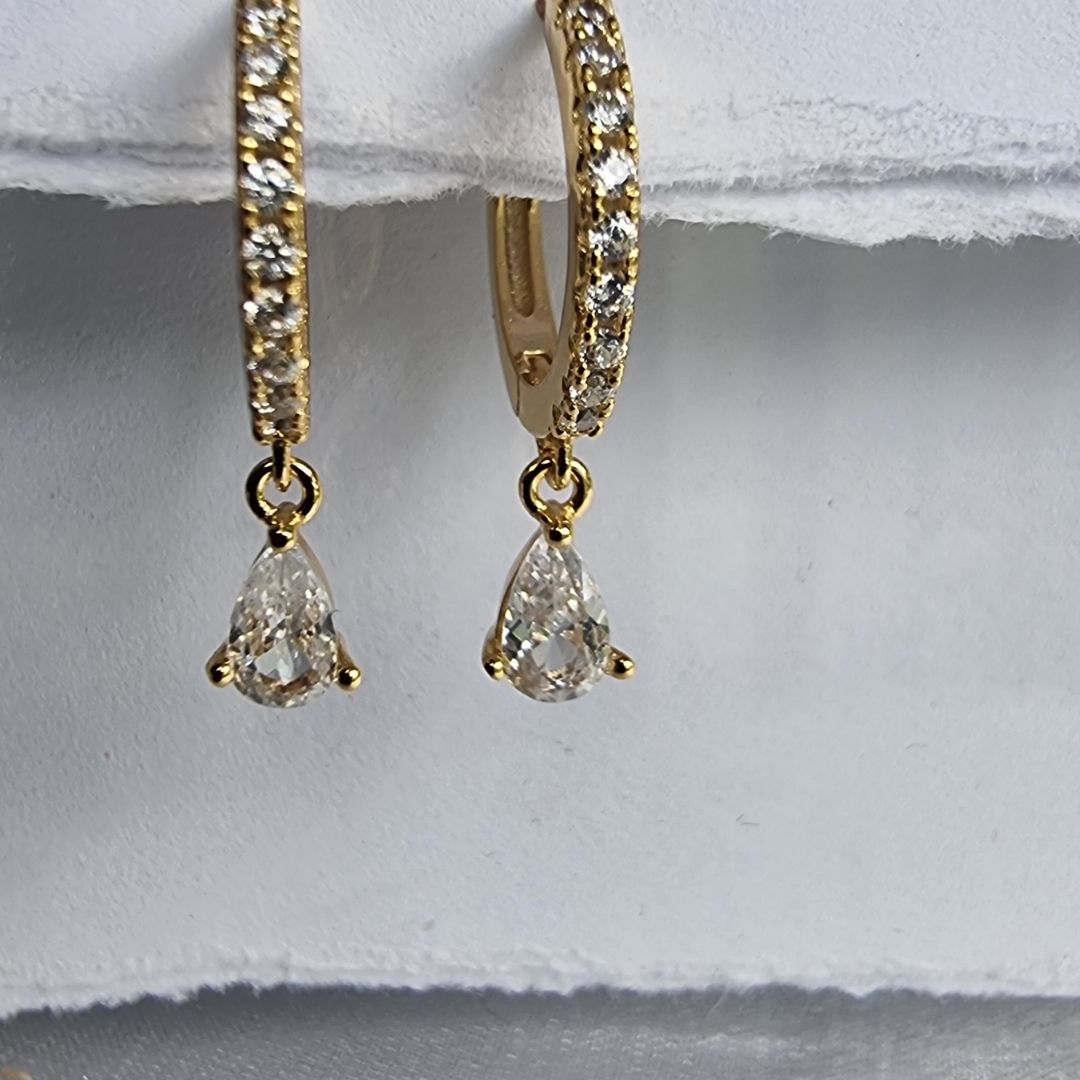 Dainty white zirconia ear piercings with a radiant 18K gold finish over high-quality sterling silver.