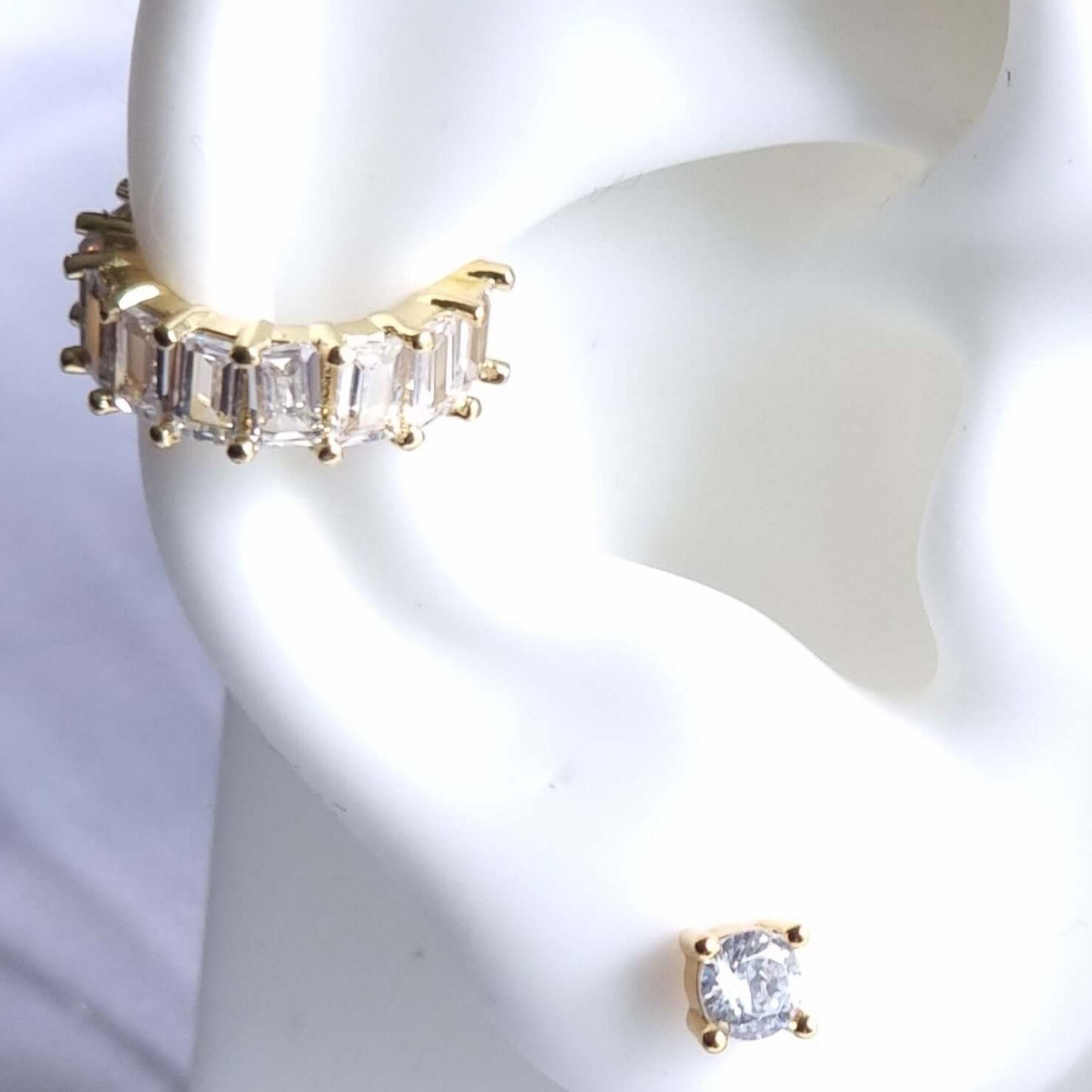 Minimalist 18K gold-plated conch ear cuff with white gem detail, designed for comfort and secure fit without needing a piercing.