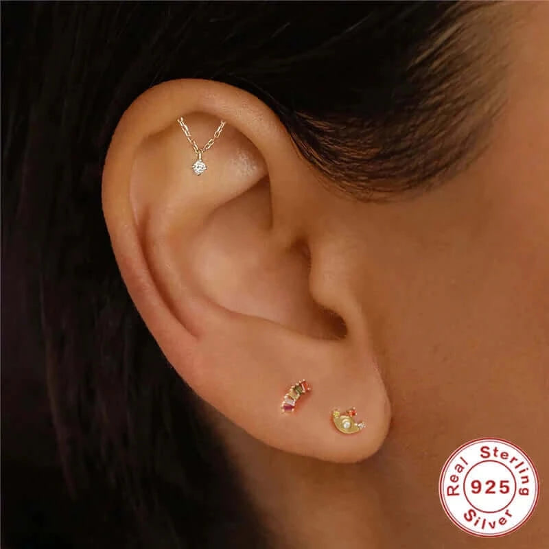 Gold hidden helix chain earring on ear