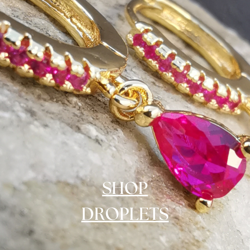 Stunning droplet earrings collection featuring elegant designs in gold and silver. Adorned with sparkling cubic zirconia, pearls, and gemstone accents, crafted from high-quality materials for a sophisticated and graceful look.