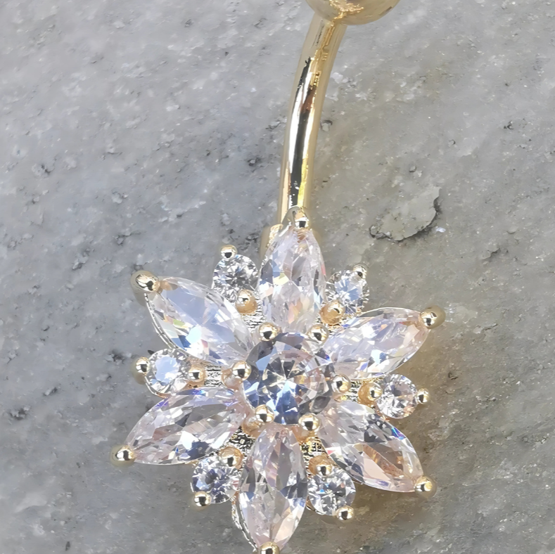 14 gauge gold curved navel barbell featuring a white enamel flower end for belly button piercing.