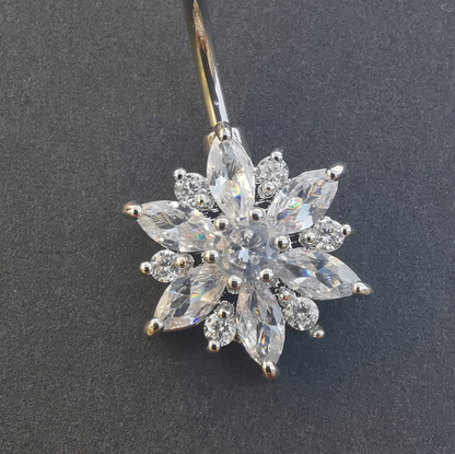 14 gauge 316L surgical steel belly button ring with a polished silver flower charm.