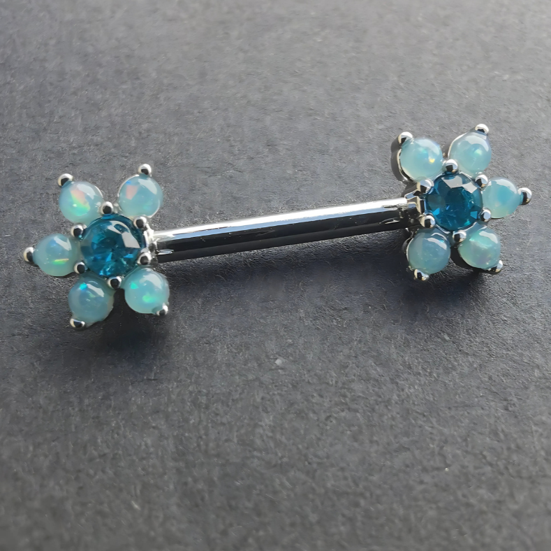 Elegant blue pearl flower nipple bar in 14G silver surgical steel 316L, accented with sparkling cubic zirconia.