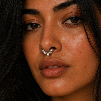 Close-up of a person with a nose ring against a dark background