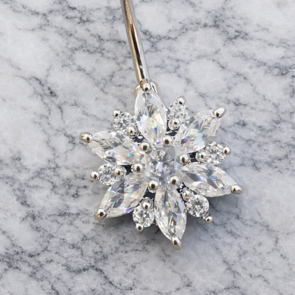Diamond flower belly button bar on a marble background