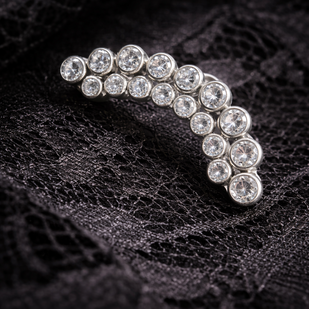 Silver earring with clear gemstones on a black textured background