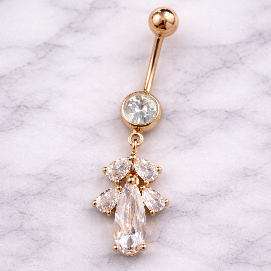 Rose Gold belly button ring with clear gemstones on a marble background