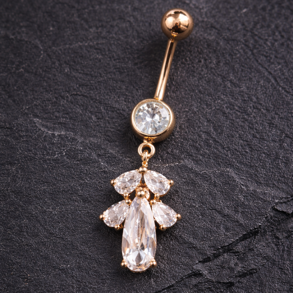 Rose Gold belly button ring with clear gemstones on a dark surface