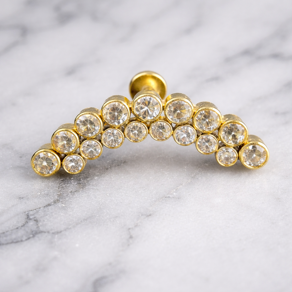 Gold dental grill with clear gemstones on a marble background