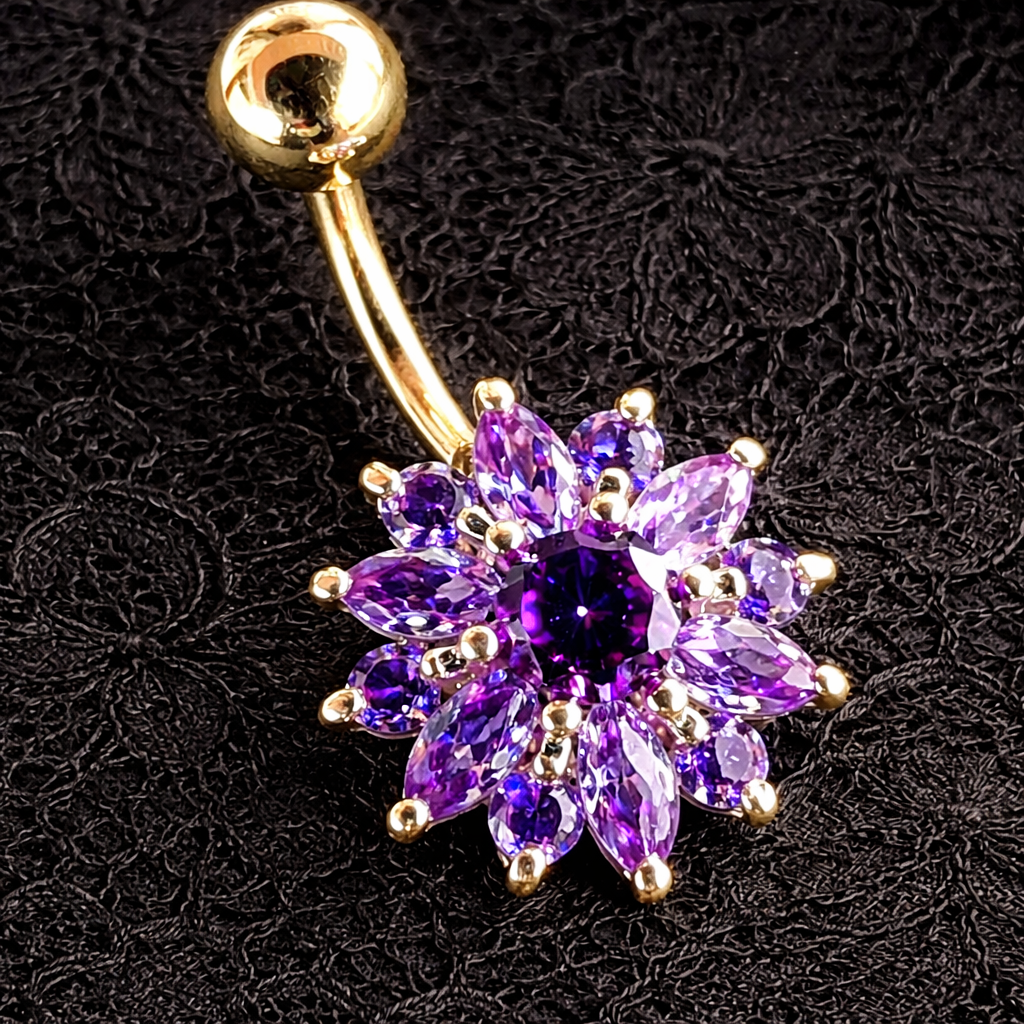 Gold belly button ring with a purple gemstone flower design on a black textured background