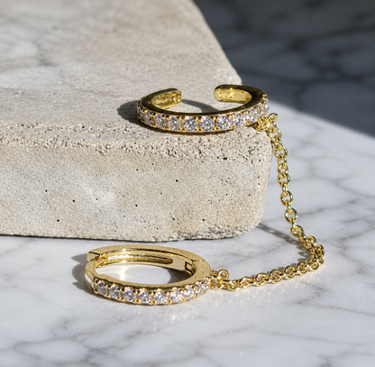 Gold bracelet with chain on a textured surface