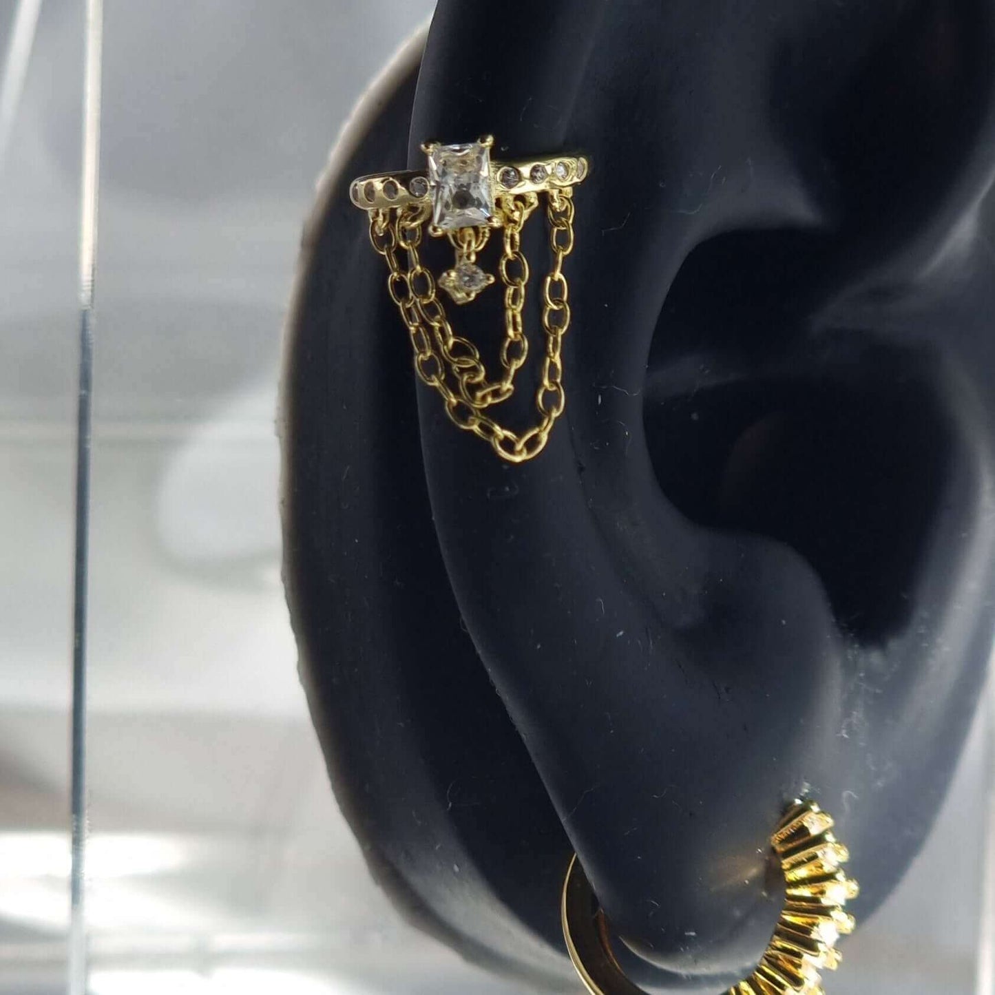 Gold ear cuff with chains on ear