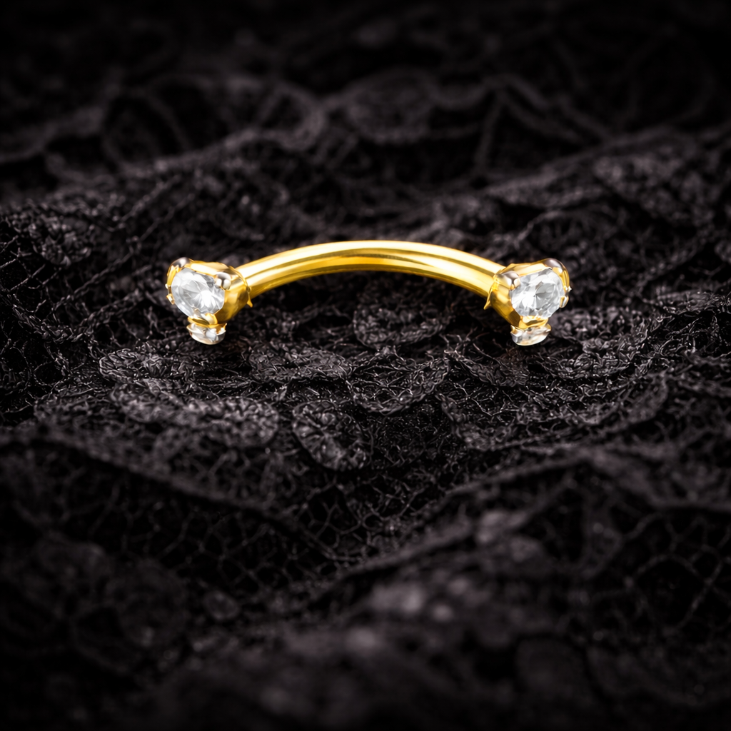 Gold eyebrow bar with cubic zirconia on a black lace background
