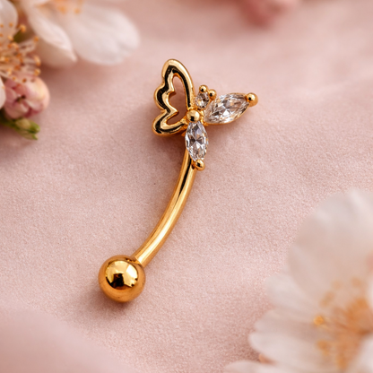 Gold eyebrow/rook bar with butterfly design on a pink floral background